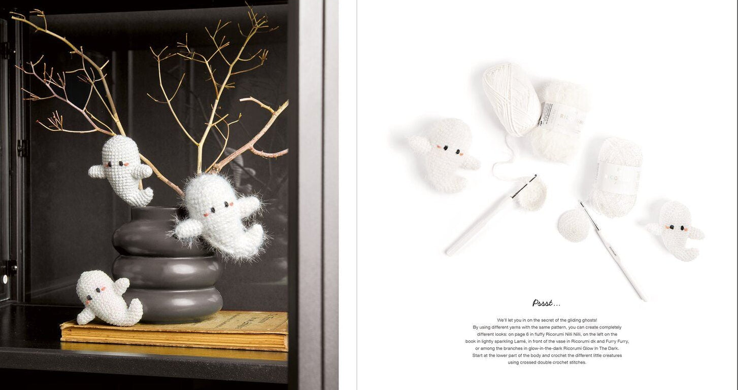 A two-page crochet pattern booklet spread showing finished white ghost-shaped plush toys and yarn needles, alongside a photo of the ghost toys displayed in a dark cabinet. The left page includes decorative branches and a small book, while the right page has a white background with the word 'Psst'
