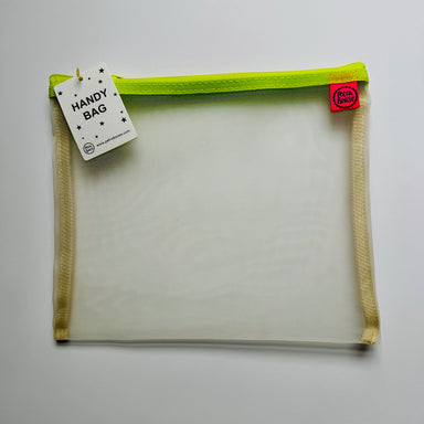 Handy bag with green zipper and tags on a light gray background