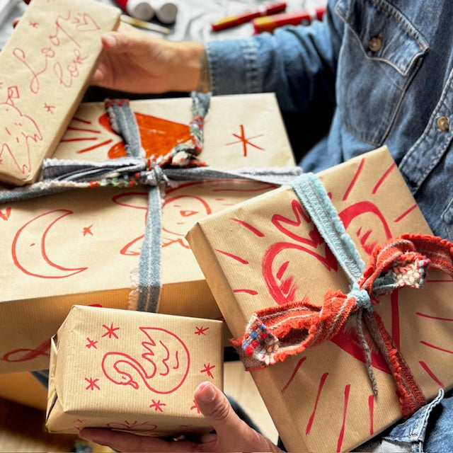 Person wrapping gifts with decorative paper and ribbons