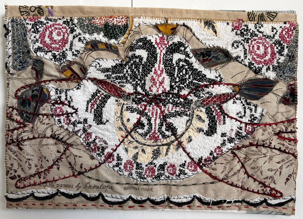 Textile art piece with intricate patterns and colors on a white background