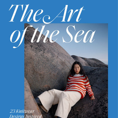 Book cover of 'The Art of the Sea' with a person sitting on rocks and a blue background.
