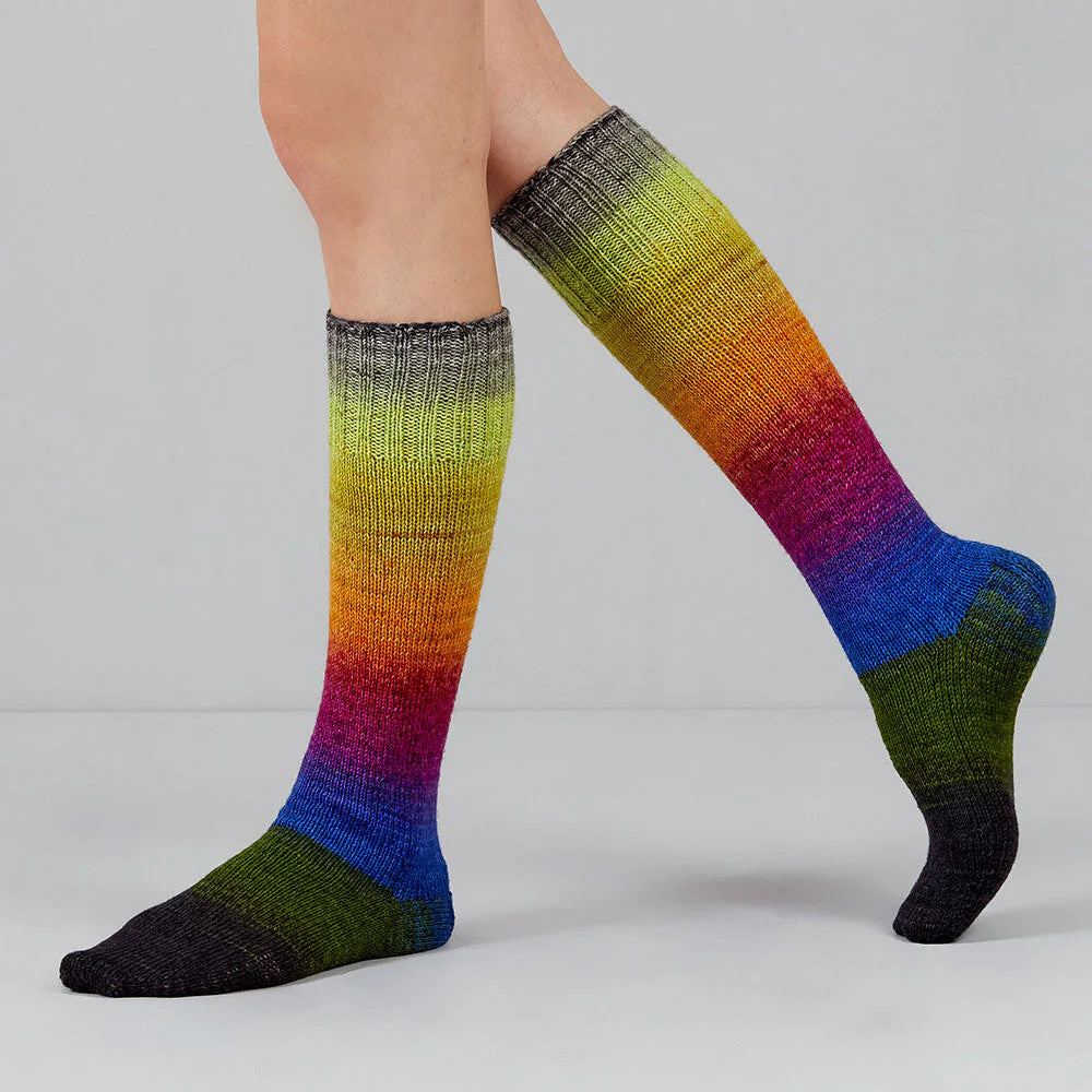 Colorful knee-high socks with a gradient pattern on a plain background
