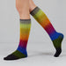 Colorful knee-high socks with a gradient pattern on a plain background