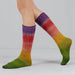Colorful gradient socks worn by a person on a plain background