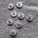 Set of decorative buttons with animal prints on a textured fabric background