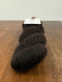 Three skeins of dark brown yarn on a wooden surface with a white background