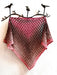 Knitted shawl with a gradient pattern on a white background with decorative birds on a branch.
