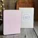 Pink notebook with geometric pattern and 'Limited Edition' box on wooden surface