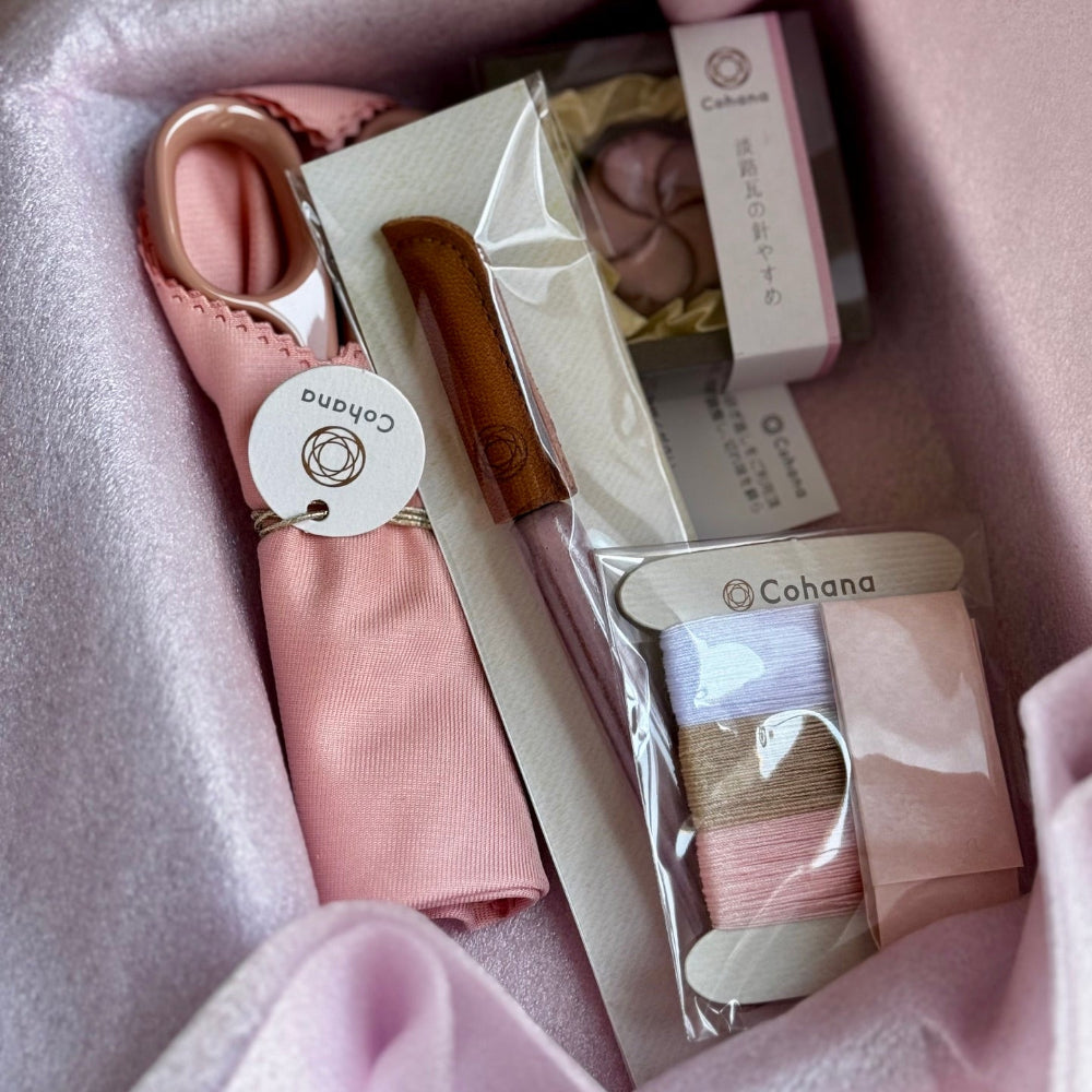 Set of sewing tools including scissors and thread in a box with 'Cohana' branding.