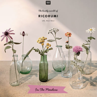 A book cover titled "The lovely world of RICORUMI" by Ume, Niels Niels, featuring several glass vases with dried and fresh flowers on a tabletop against a soft beige background. The cover includes the publisher mark "BLOOM" at the top and a pink banner reading "In The Meadow" near the bottom.