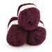 Three skeins of dark red yarn stacked on a white background