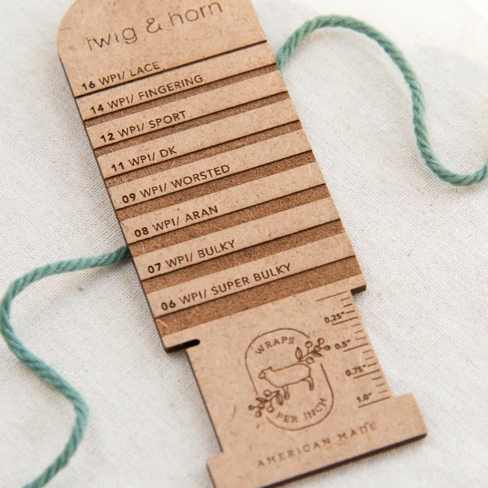 Wooden yarn weight chart with measurements on a white background