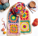 Colorful crocheted squares with yarn and a cup of coffee on a white surface