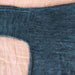 Close-up of blue denim fabric on a beige surface