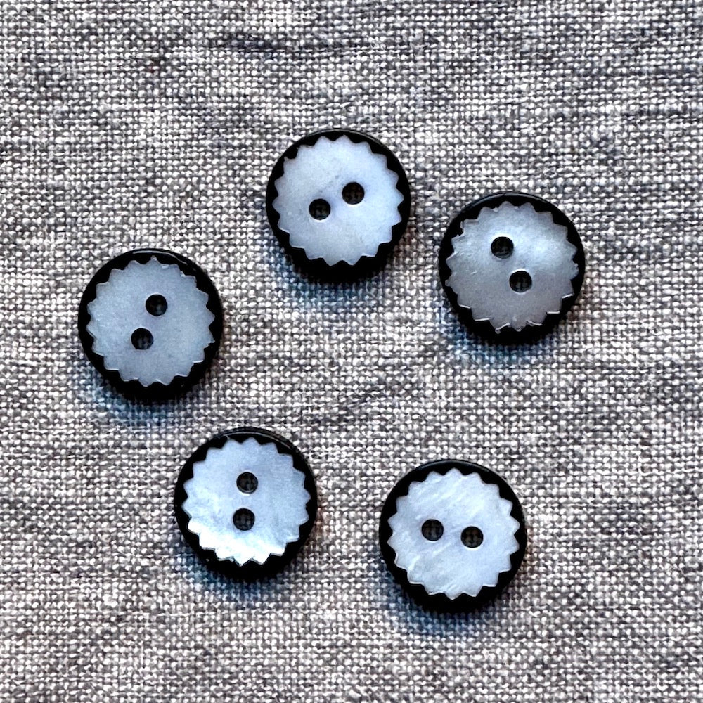 White shell button with scalloped edge