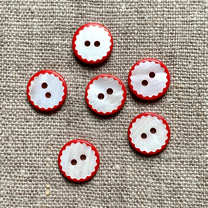 White shell button with red scalloped edge