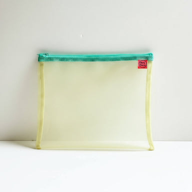 Clear mesh pouch with blue zipper and red tag on a neutral background