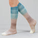 Knitted knee-high socks with a gradient color pattern on a gray background