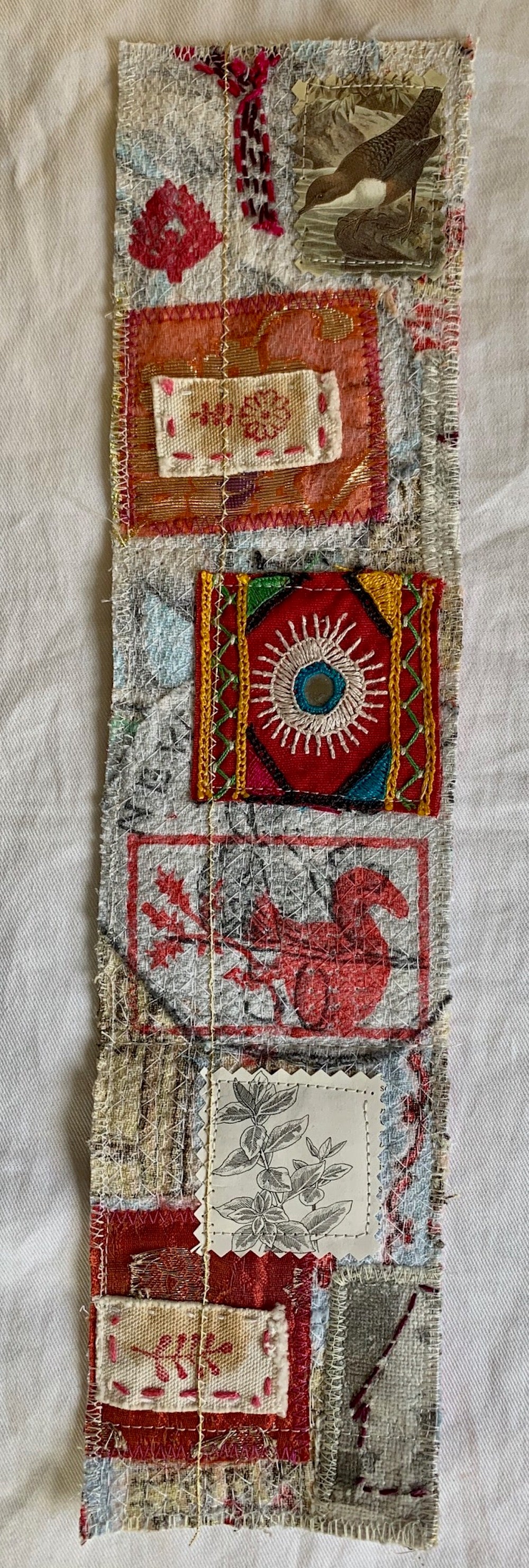 Textile strip with various patterns and colors on a textured background