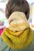 Person wearing a yellow knitted scarf with a blurred background