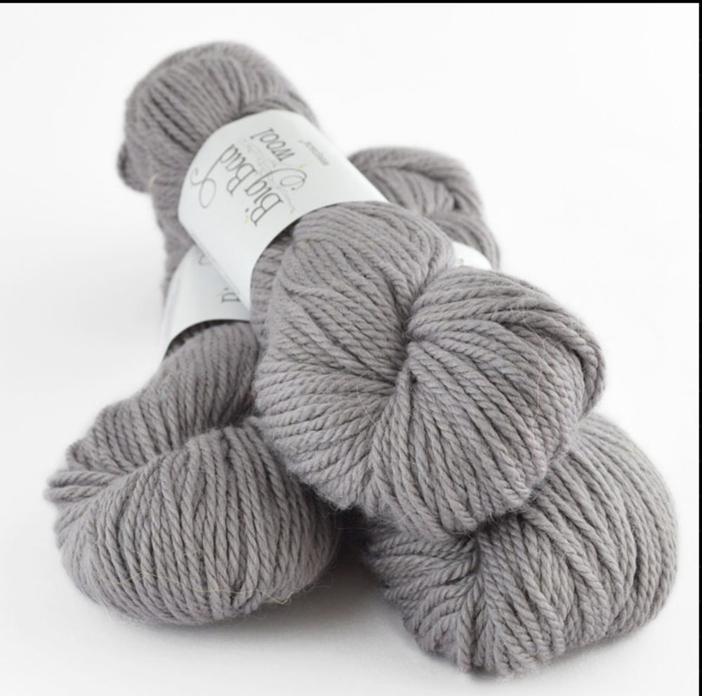 Gray skein of yarn with a label on a white background