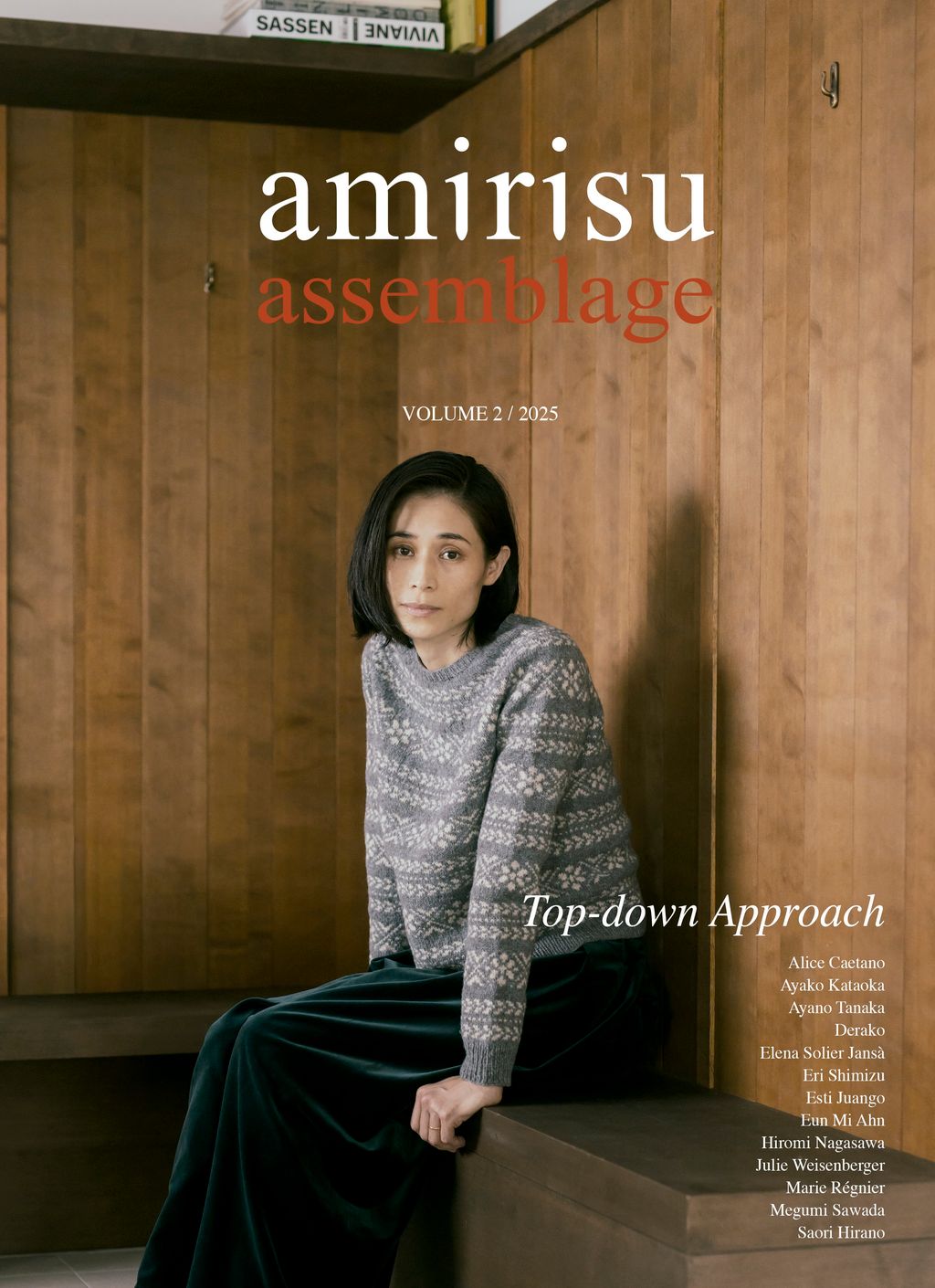 Magazine cover titled 'amirisu assemblage' with a woman sitting against a wooden wall.